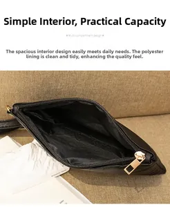Detail of black leather clutch with golden zipper and spacious polyester lining interior