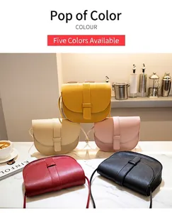 Detailed close-up of saddle-shaped crossbody bags in five colors on marble surface