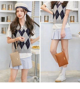 Detailed close-up of quilted PU leather clutches in beige and brown with wristlet straps