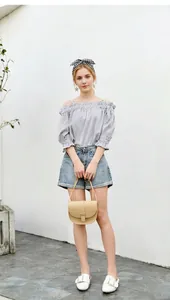 Full view of blue gingham off-shoulder top, denim shorts and cream saddle bag set