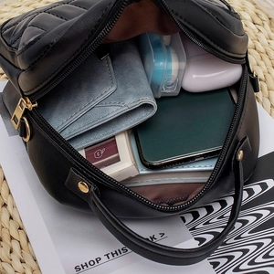 Quilted black leather handbag with gold chain strap and spacious interior for daily essentials
