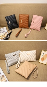 Detail of quilted PU leather envelope clutch with V-pattern stitching and gold hardware