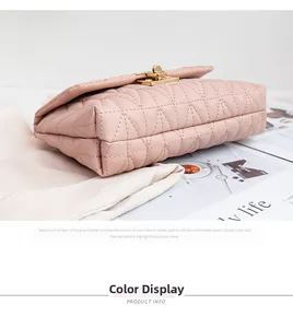 Close-up of pink quilted leather bag featuring a gold twist lock and diamond stitch pattern