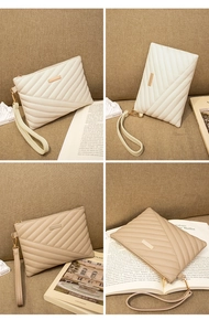Close-up of quilted PU leather envelope clutch with metallic accent and wrist strap