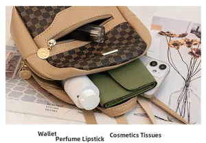 Internal view of mini crossbody bag showing storage for phone, wallet and lipstick