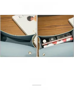 Detail view showing internal storage space of the light blue leather crossbody bag