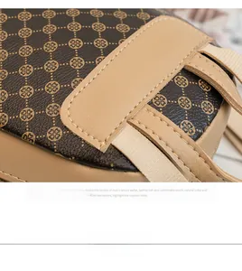 Macro detail of brown leather bag showing clover print, fine stitching, and premium texture
