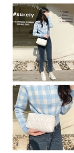Detail of white quilted crossbody camera bag with BAG.1980 lettered wide fabric strap