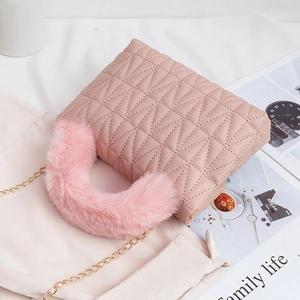 Elegant pink quilted handbag with fur-wrapped handle and gold chain strap for women