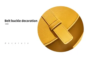 Detail of yellow saddle bag featuring textured lychee leather and stylish buckle decor