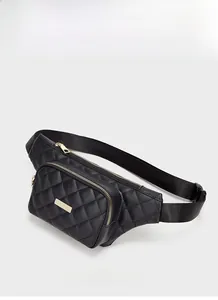 Detailed 45-degree angle view of black quilted leather waist bag with gold zipper