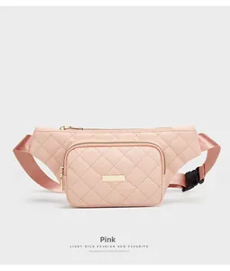 Detailed close-up of a pink quilted fanny pack with gold zippers and adjustable strap