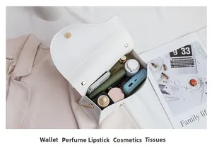 Internal view of white saddle bag showing capacity for wallet perfume and lipstick
