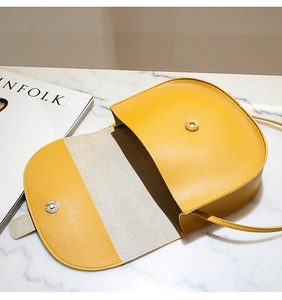 Top view of yellow saddle bag interior with magnetic snap closure and lining