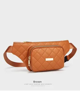 Detail of brown quilted waist bag featuring gold zipper and nylon shoulder strap buckle