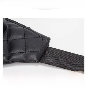 Close-up of quilted leather waist bag showing reinforced stitching and nylon strap