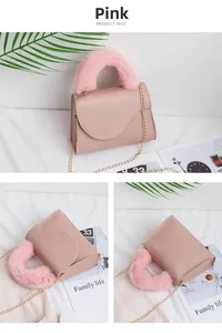 Detailed view of pink leather crossbody bag with faux fur handle and gold chain strap