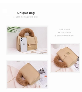 Detail of cream crossbody bag with plush brown handle and gold metal twist lock