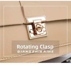 Close-up of golden rotating metal lock on a beige leather chain crossbody bag