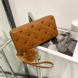Brown woven leather wallet with heart embroidery, wrist strap and pompom charm detail