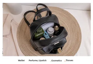 Interior view of black quilted mini backpack showing storage space for cosmetics and essentials