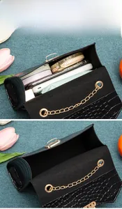 Detail showing the internal storage capacity of the black crocodile pattern handbag