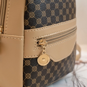 Women's backpack with clover pattern and metallic accents for casual style