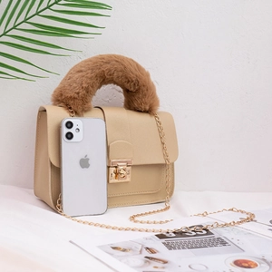 Minimalist beige crossbody chain bag with brown faux fur handle and gold metal clasp