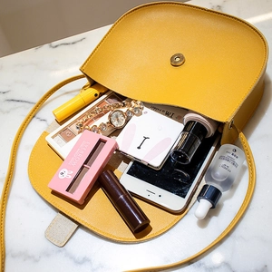 Bright yellow PU leather saddle shoulder bag with interior storage for phone and makeup
