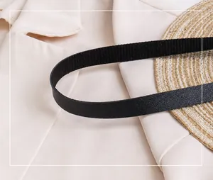 Detail shot of a flexible black pebbled leather shoulder strap for a versatile backpack