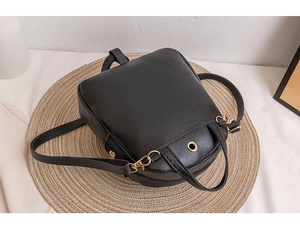 Detail view of mini quilted backpack with gold headphone port and versatile straps