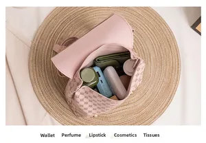 Detail view of pink printed backpack interior showing storage for wallet and cosmetics
