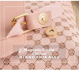 Close-up of pink printed backpack featuring a gold magnetic buckle and textured leather