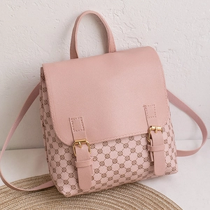 Detail view of pink monogram backpack featuring golden buckle and textured flap