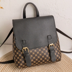 Close-up of vintage floral backpack with leather flap and golden buckle details