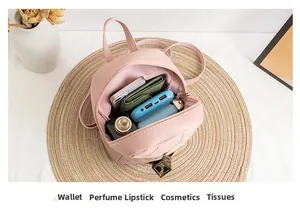 Pink quilted mini backpack interior showing storage for phone, wallet, and lipstick