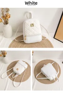 Detailed view of white quilted mini backpack featuring gold hardware and sleek faux leather