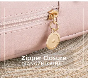 Close-up of durable metal zipper closure on pink litchi texture leather backpack