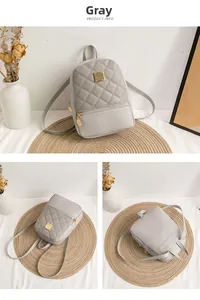 Detail view of grey quilted mini backpack with gold buckle and stylish PU leather texture