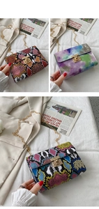 Detail of colorful snakeskin and tie-dye patterns on small chain bags with gold clasps
