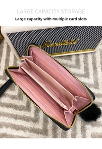 Interior view of black long wallet featuring multiple card slots and pink lining