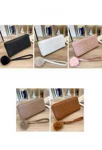 Detail view of long wallets with V-quilt stitching in black, white, pink, khaki and brown