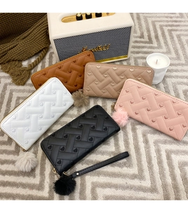 Selection of long zip-around wallets with heart quilting and fluffy pompom charms