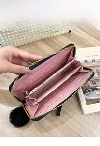 Close-up of women's long zipper wallet with multiple card slots and pink interior
