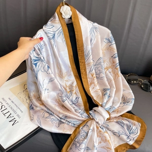 Elegant floral print satin scarf in beige and blue with a stylish dark brown border