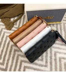 Close-up of long clutch wallets featuring heart-shaped quilted pattern in five colors