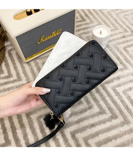 Close-up of quilted PU leather long wallets with heart embroidery and plush ball charms