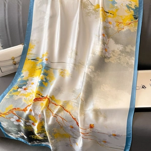 Elegant silk scarf with plum blossom and landscape print on sofa with handbag