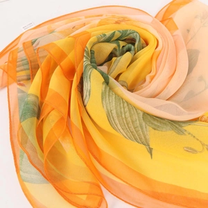 Elegant floral georgette scarf with bright yellow and orange leaves in a soft pile