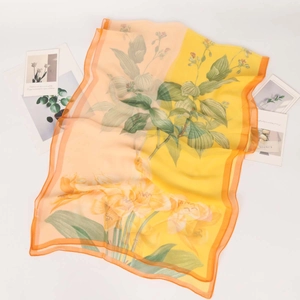 Lightweight georgette silk scarf with yellow floral print and translucent chiffon texture